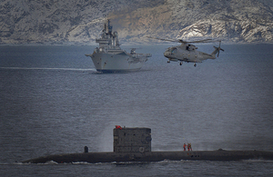 HMS Ark Royal in the distance in company with HMS Talent as the submarine conducts a high-line transfer off the Northern Coast of Norway [Picture: LA(Phot) Gregg Macready (RN), Crown copyright]