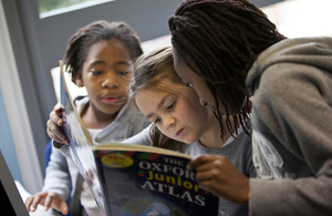 children reading an atlas