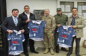 Lieutenant Colonel David Jones presenting the new rugby uniform to Kosovo Roosters Rugby Club outside British Embassy Pristina. Left to Right: Veli Hoti, Philip Mellish; Lt Col David Jones; Dukagjin Hysenaj and Denis Dautaj