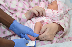 Newborn baby having a blood spot test