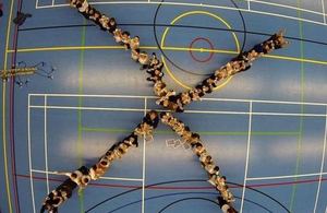 Multiple students form 'X' shape.