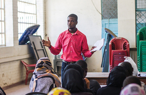 Adam Smith International adviser talking with community stakeholders in Kenya