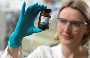 Woman inspecting a label on a chemical bottle