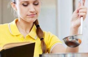 Image of girl in a yellow top with a cookbook ladle and spoon