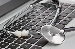 Image of a stethoscope lying on a keyboard.