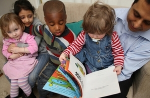 Children reading with man