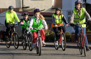 Family cycling in park