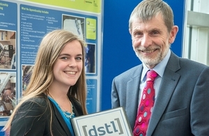 Emma Treadwell receiving her apprenticeship graduation certificate from Dstl Chief Executive Jonathan Lyle