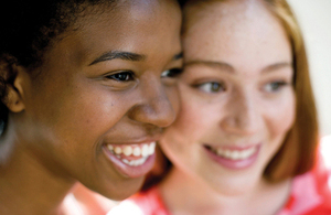 A headshot of two girls smiling