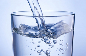 Water being poured into a glass.