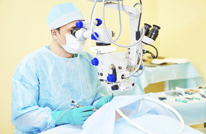 Eye surgeon carrying out surgery