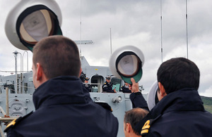 Sailors lift their hats in salute as HMS Bangor departs Faslane to support NATO operations in the Mediterranean