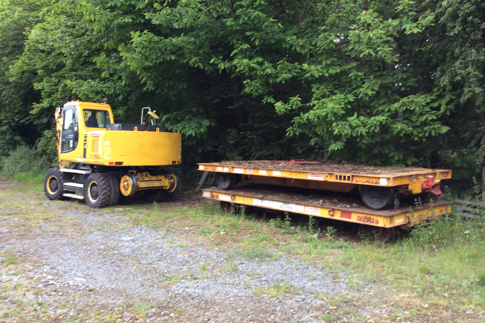 Image showing the road rail vehicle and trailers used to collect the scrap sleepers (image courtesy of Network Rail)