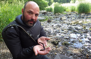 Environment Agency officer holding an eel