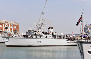 The crew of HMS Brocklesby line the decks as the ship returns to Portsmouth Naval Base