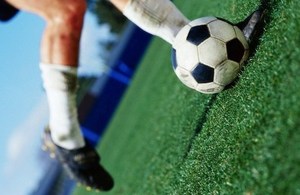 Image of a football ball on a stadium