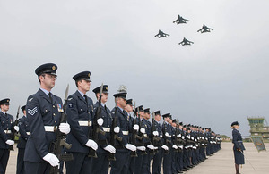 Four Tornado aircraft fly overhead as members of 14 Squadron RAF parade for the final time at RAF Lossiemouth in Scotland