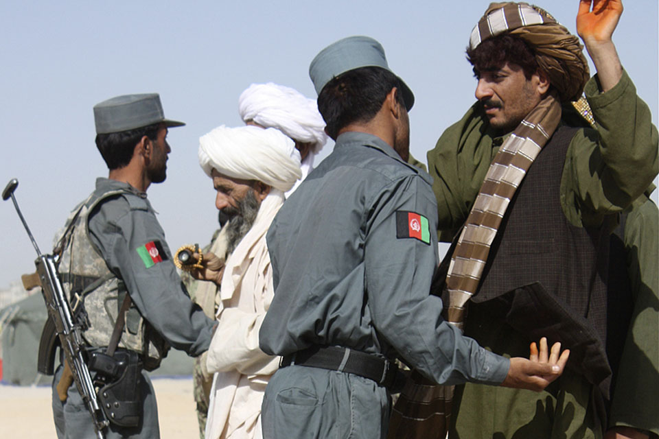 Afghan policemen carry out searches of members of the public (stock image)