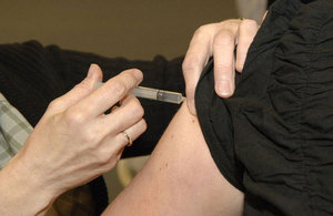 A persons arm getting a vaccination