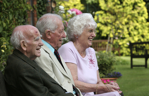 Three OAPs sitting happily on a bench