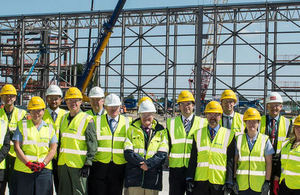 DIO project manager Denis Williams (front centre) with partners celebrating the first stage of the hangar’s steelwork. (MOD Crown Copyright)