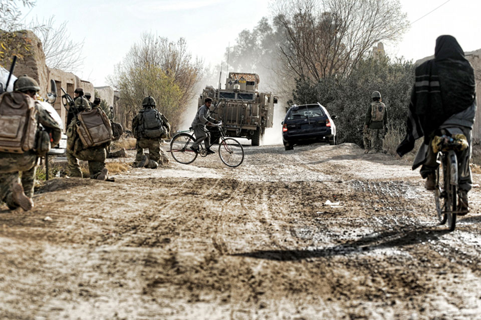 Soldiers from 3 PARA patrol through the busy town of Naqilabad Kalay