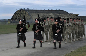 Soldiers of the 1st Royal Tank Regiment march into their base at RAF Honington led by Army pipers