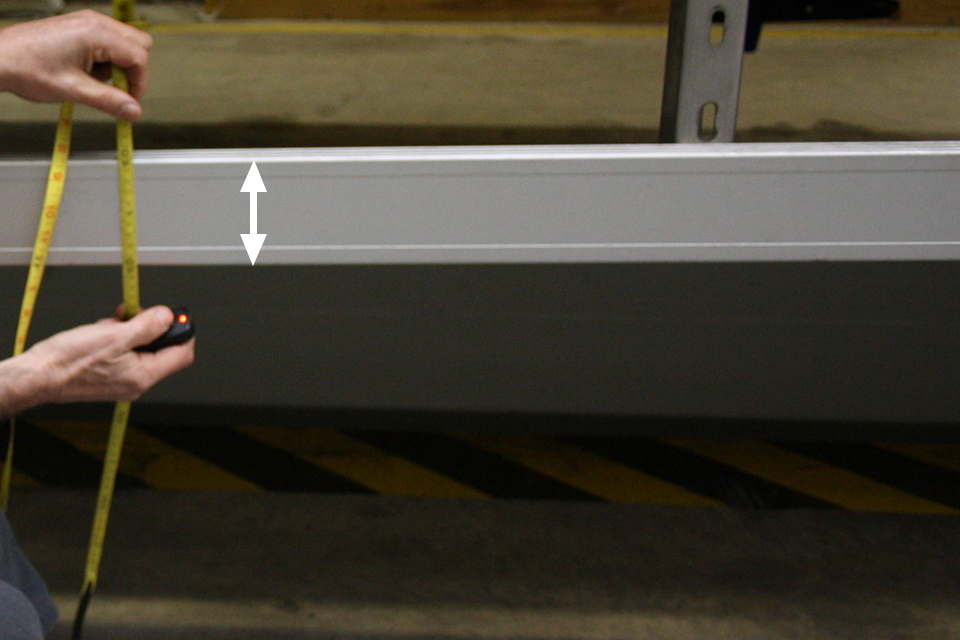DVSA measure the height of the rail.