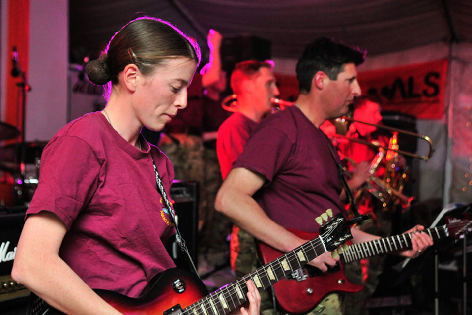 The Band of The Parachute Regiment performs in the 'Dutch Corner' (Dutch welfare facility) in Kandahar under the name of Ripcord. Musician Kate Whittaker is pictured closest to camera with her guitar
