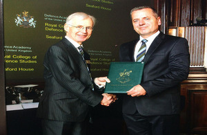 General Hazrolli receiving his graduation diploma from Sir Tom Phillips