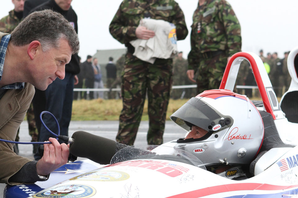 Racing legend Mario Andretti at the wheel of his car at RAF Honington