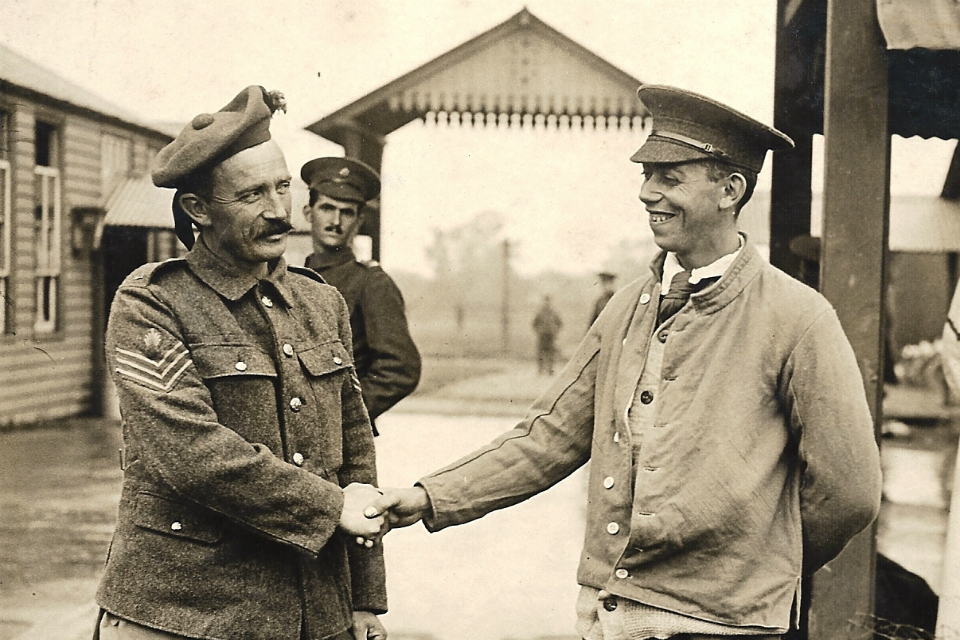 Fred Potts shaking hands with his Enniskillin Fusilier rescuer.