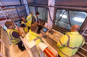 Pete Lutwyche, right, and John Clarke, centre back, watch as super-compacted pucks of Low Level Waste (LLW) are loaded into containers before being consigned to the LLW vaults