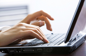 A person typing on a laptop computer.