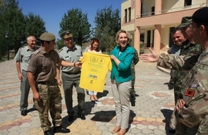 The Albanian Minister of Defence Mrs Mimi Kodheli receives a gift from the Welsh Guard STTT – a T-Shirt symbol of the first 100 Anniversary of the Regiment.