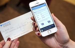 Mobile phone using a cheque imaging application to photograph a cheque