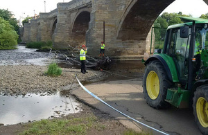 Operations team drags debris from the river