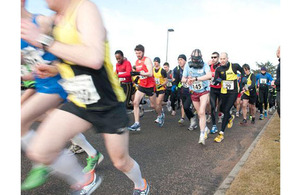 Senior Aircraftman Andy McMahon completing the Kinloss-to-Lossiemouth half-marathon in his Service respirator, in record time