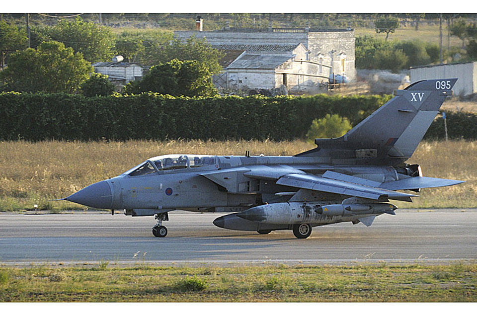 An RAF Tornado GR4, flown by a crew from 12 Squadron, with RAPTOR (Reconnaissance Airborne Pod for Tornado) intelligence-gathering capability taxis on the runway at Gioia del Colle, southern Italy 