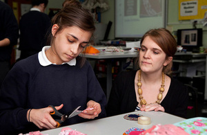 A girl and teacher in a textiles class.