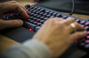 Person typing on a keyboard.