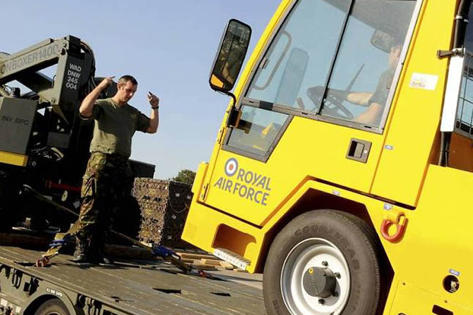 A member of the Defence Support Group reverses a truck from the back of a low loader at Gioia del Colle in southern Italy  