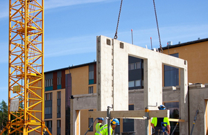 Construction site crane is used to place precast concrete panels