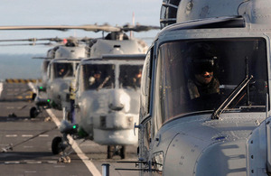 702 Naval Air Squadron's Lynx Mk8 helicopters line the flight deck of HMS Illustrious