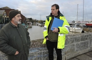 Environment Agency staff talking to a resident about flooding.