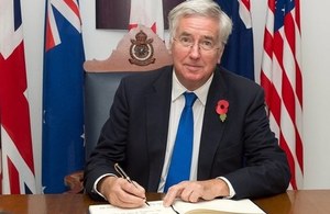 Defence Secretary Michael Fallon signs the visitors' book at RAF Wyton, home to the Joint Forces Intelligence Group, which is part of Defence Intelligence.