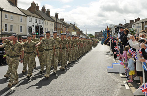 Personnel from RAF Leeming pass through Bedale market place where Air Commodore Russ La Forte and Councillor Mrs Amanda Coates, Mayor of Bedale, take the salute