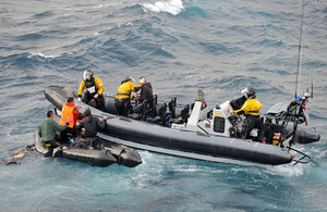 HMS Cornwall's sea boat recovers five people from a damaged four-metre inflatable boat