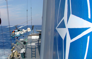 A NATO helicopter lands on a frigate