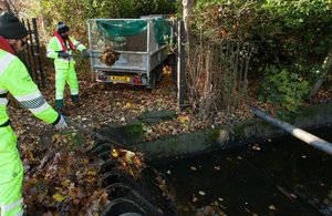 Field service operatives clearing blockages to reduce flood risk